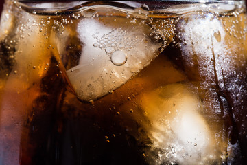 Cola with ice cubes in a close-up glass
