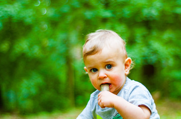 Portrait of a Baby Boy with Blue Eyes in park