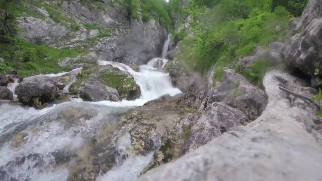 Water flow, river flowing between the rocks in a forest in the Alps mountains, Europe
