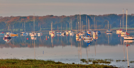 Yachts moored in Chichester Harbour at Apuldram, (Fishbourne Channel), West Sussex, England, UK.