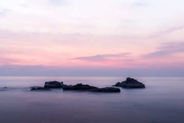 Obraz premium Colorful Sunset Soft Light on the Beach with Rocks