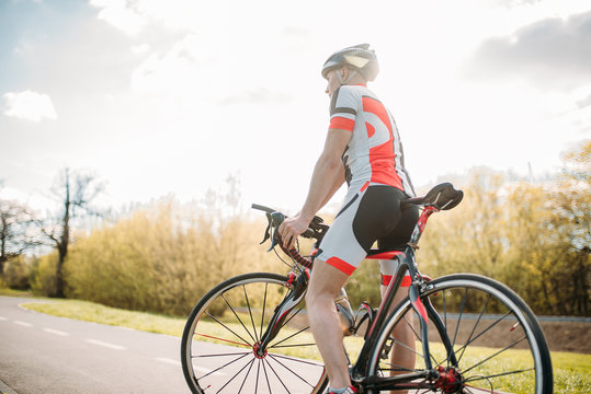 Bycyclist in helmet and sportswear on bike workout