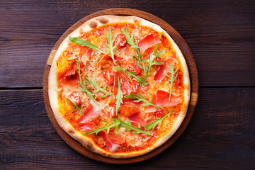Pizza with prosciutto, unhealthy fattening junk food, popular high-calorie snack. 