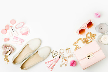 Fototapeta premium Flat lay of female fashion accessories, shoes, makeup products and handbag on pastel color background. Beauty and fashion concept