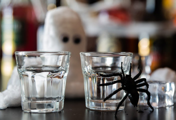 creepy halloween party cocktails with syringes of grenadine syrup as blood, shot drinks at party