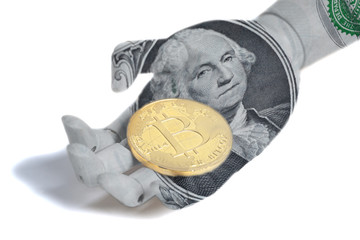 Wooden robot hand with portrait of George Washington one U.S. dollar bill holding bitcoin