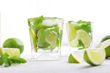 Refreshing mint alcohol cocktail Mojito with rum and lime, cold summer drink lemonade with ice,...