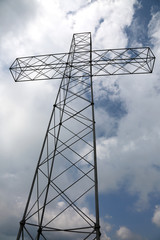big cross in vertical and many clouds