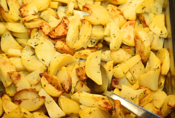 Roasted potatoes  on the tray of a self-service restaurant