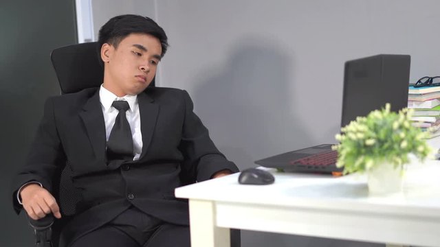 young business man sitting on chair and thinking