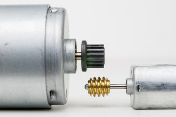 Small electric motor on a white workshop table. Electric drive used in small electrical devices.
