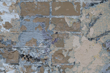 Background of old color vintage stonewall with peeling plaster texture. Abstract design element