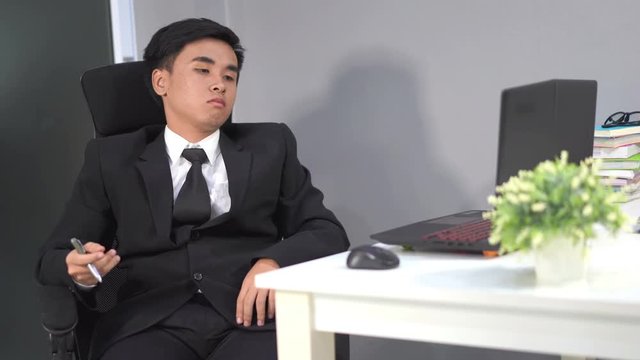 young business man sitting on chair and thinking