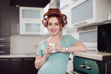 Portrait pregnant woman drinking tea