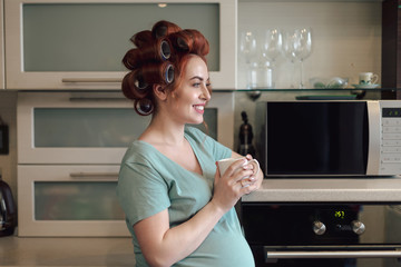 Fototapeta na wymiar Profile portrait pregnant woman holding a cup tea