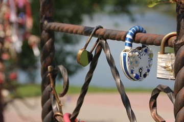 Decorative wedding locks on forged iron fence