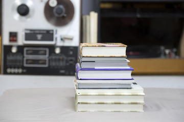 Book, stack of hardback books on table. Top view.