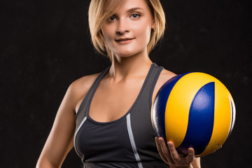  Girl beach volleyball player on a dark background