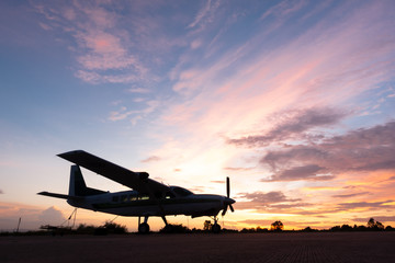 beautiful landscape image with silhouette of old wing airplane at sunset