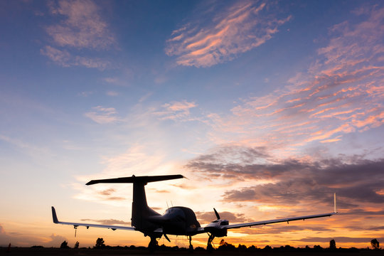 beautiful landscape image with silhouette of old wing airplane at sunset