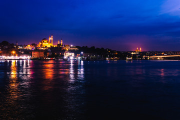 Fototapeta na wymiar Night view of Istanbul. Panorama cityscape of famous tourist destination Golden Horn bay part of Bosphorus strait. Travel illuminated landscape Bosporus, Turkey, Europe and Asia.