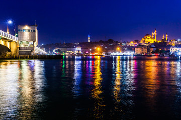 Fototapeta na wymiar Night view of Istanbul. Panorama cityscape of famous tourist destination Golden Horn bay part of Bosphorus strait and Galata bridge. Travel illuminated landscape Bosporus, Turkey, Europe and Asia.