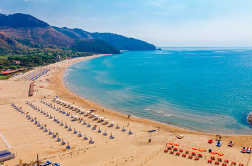 Beach and sea landscape with Sperlonga, Lazio, Italy. Scenic resort town village with nice sand beach and clear blue water in picturesque bay. Famous tourist destination in Riviera de Ulisse