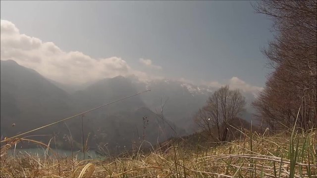 Time lapse (static) of clouds moving upon a mountain wilderness environment