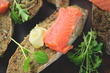 Bruschetta sandwich with trout and butter and arugula. Healthy diet. Omega 3