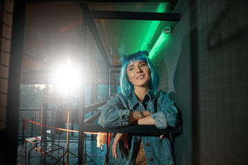  Portrait of young beautiful pop woman wearing a blue wig