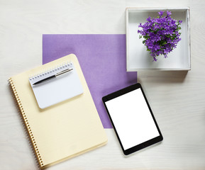 flat lay concept with writing pad, pen and beautiful violet flowers, can be used as background 