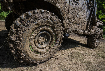Fototapeta na wymiar Wheels of off road car stuck full of mud 