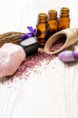 Spa background with the bottle of essential oils and massage stones