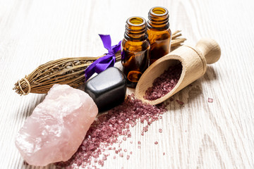 Spa background with the bottle of essential oils and massage stones