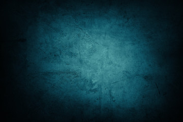 Blue textured concrete wall background. Dark edges