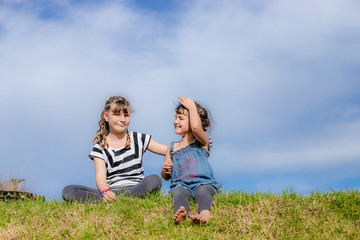 outdoor portrait of young happy child girl having fun on natural background