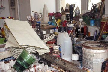 Desk in the watchmaker's workshop with paint cans