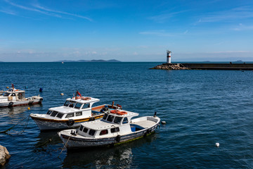 Fototapeta premium Istanbul, Marmara Sea, boats and lighthouse in afternoon