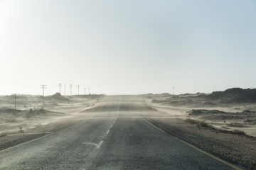 Fototapeta premium Sand Storm Across Lonely Desert Road in Southern Namibia taken in January 2018