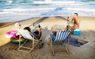 Senior friends having a drink at the beach