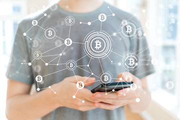 Bitcoin with young man using a smartphone