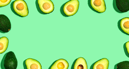 Fresh avocado pattern on a green background flat lay