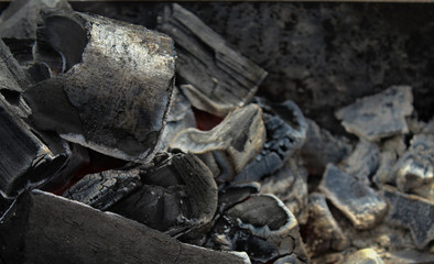 Wooden coals in the grill close-up