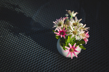 Flowers in a vase are placed on the table.