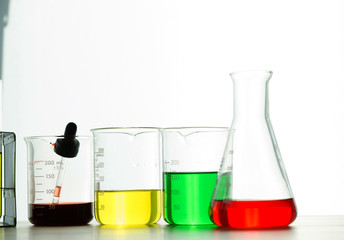 A pipette dropping sample into a test tube,abstract science background