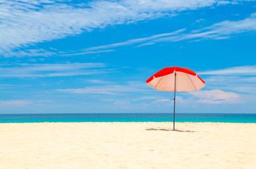 Fototapeta na wymiar red umbrella beach white sand and blue sky