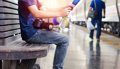 Young man traveler with map on street building background