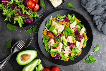 Salad with fish. Fresh vegetable salad with salmon fish fillet. Fish salad with salmon fillet and fresh vegetables on plate