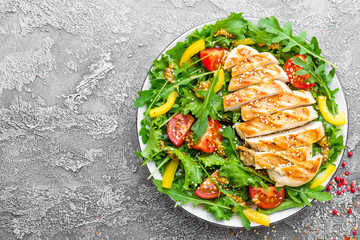 Chicken salad. Meat salad with fresh tomato, sweet pepper, arugula and grilled chicken breast. Chicken fillet with fresh vegetable salad