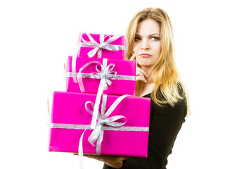 Confused woman holding gifts